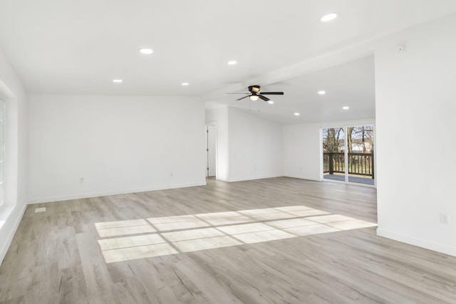 empty room with baseboards, light wood-type flooring, vaulted ceiling, recessed lighting, and a ceiling fan