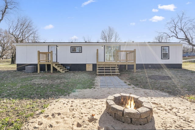 view of front of home featuring a deck and a fire pit