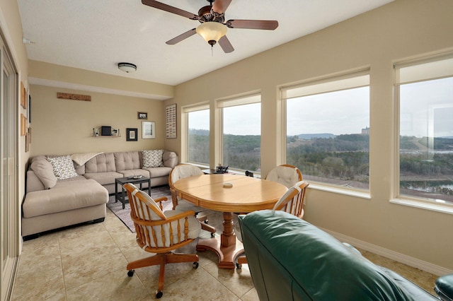 living room with light tile patterned floors and ceiling fan