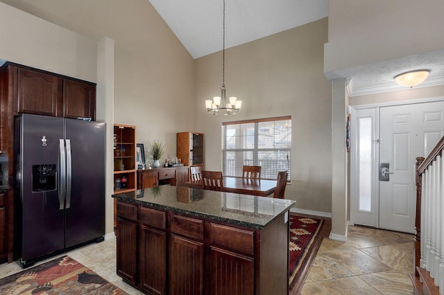 kitchen with high vaulted ceiling, stainless steel refrigerator with ice dispenser, an inviting chandelier, and a wealth of natural light