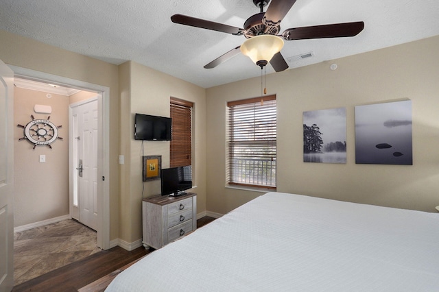 bedroom featuring baseboards, a ceiling fan, dark wood-type flooring, and visible vents