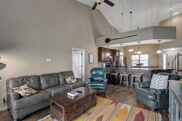 living room featuring high vaulted ceiling, ceiling fan, and wood finished floors