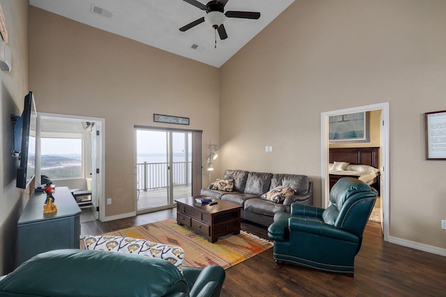 living area with baseboards, visible vents, high vaulted ceiling, and ceiling fan