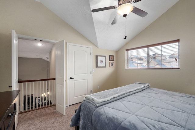 bedroom featuring vaulted ceiling, a ceiling fan, and light colored carpet