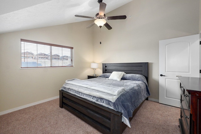 carpeted bedroom featuring lofted ceiling, a ceiling fan, and baseboards
