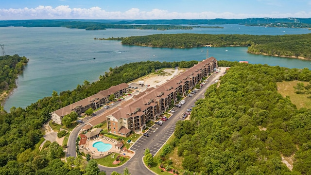 drone / aerial view featuring a forest view and a water view