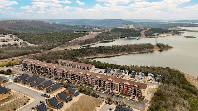 drone / aerial view with a forest view and a water view