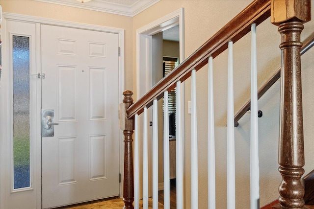 entrance foyer featuring stairway and ornamental molding