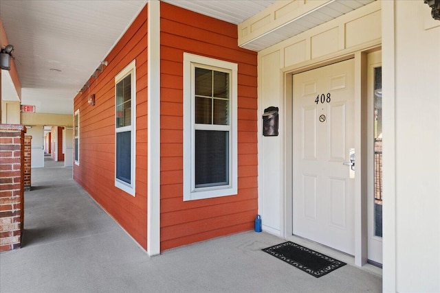 view of exterior entry with a porch