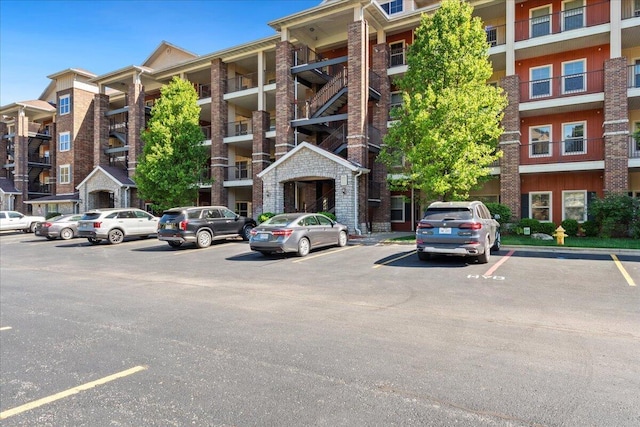 view of building exterior with uncovered parking