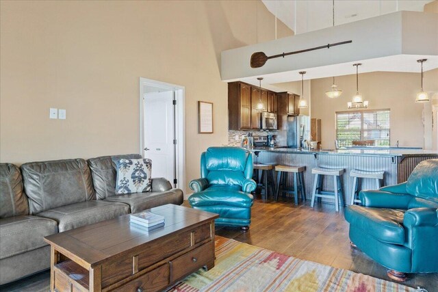 living area featuring wood finished floors and a high ceiling