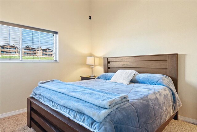 bedroom with carpet and baseboards