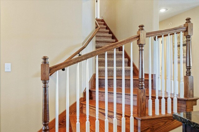 staircase featuring wood finished floors