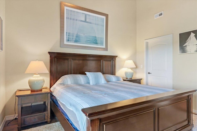 bedroom featuring baseboards and visible vents