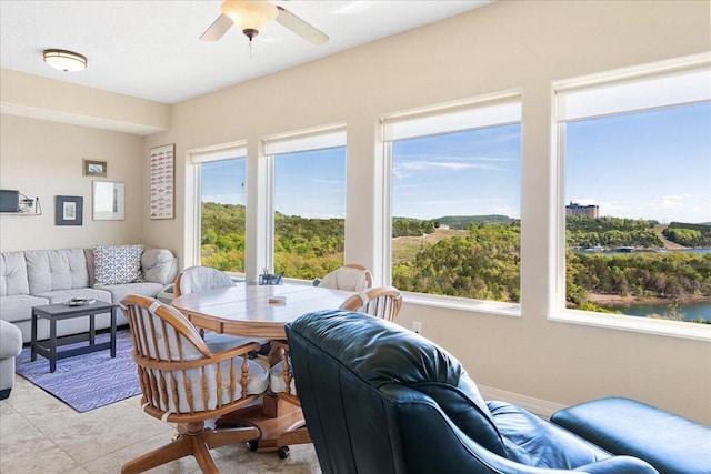 dining area featuring a wealth of natural light, ceiling fan, and light tile patterned flooring