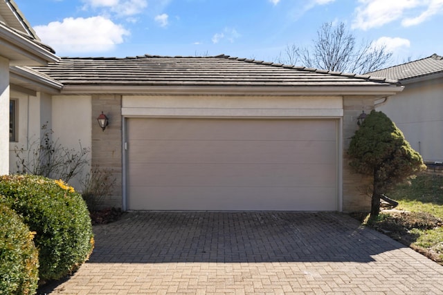 garage featuring decorative driveway