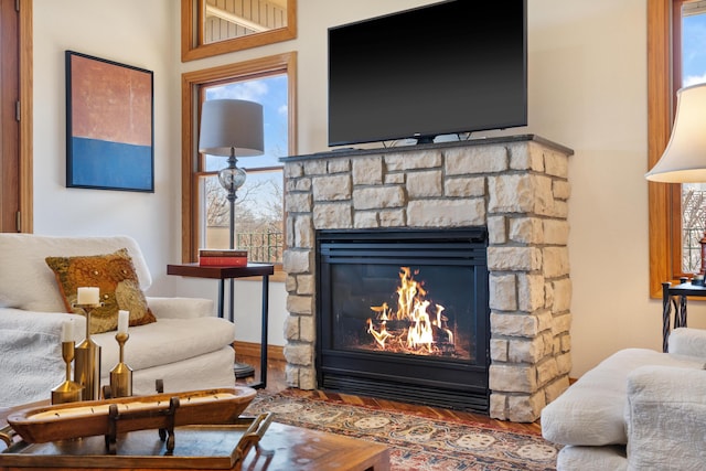 sitting room with wood finished floors and a fireplace