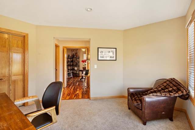 carpeted home office with baseboards