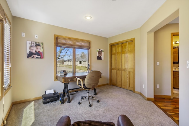 carpeted office with baseboards