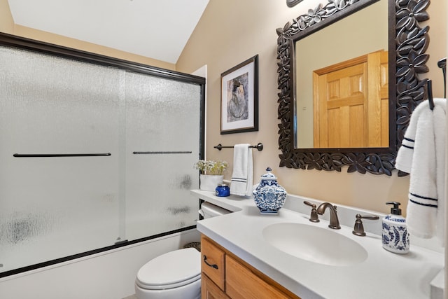 full bath featuring vanity, vaulted ceiling, toilet, and combined bath / shower with glass door