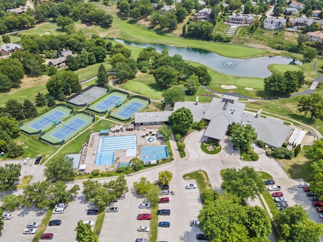 aerial view with golf course view and a water view