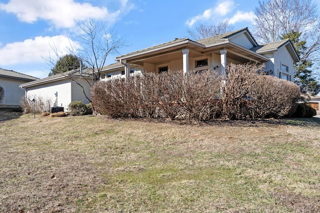 view of home's exterior with a yard and stucco siding