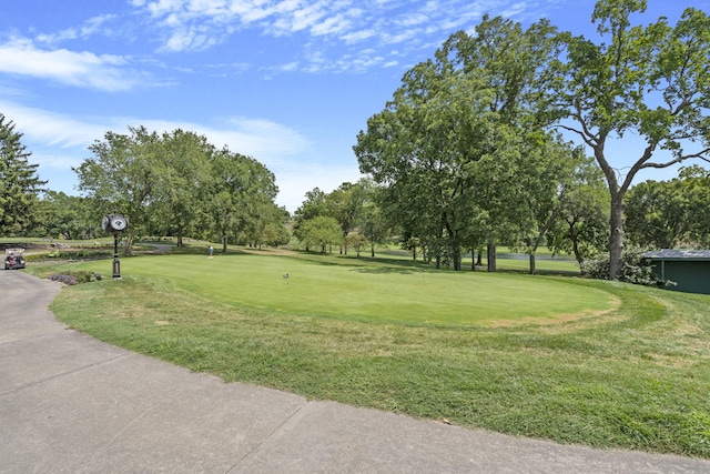 surrounding community with a lawn and view of golf course