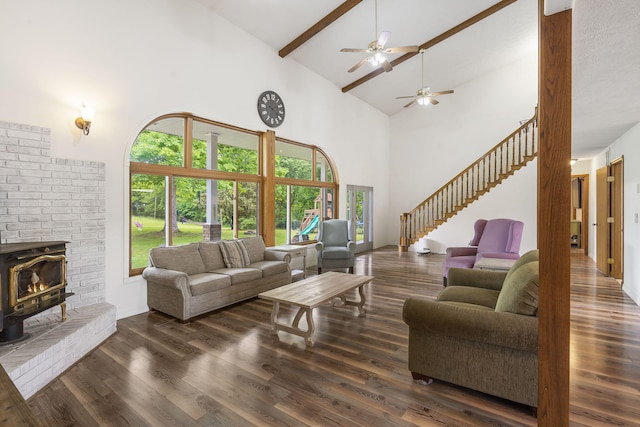 living area with ceiling fan, stairs, beam ceiling, wood finished floors, and high vaulted ceiling