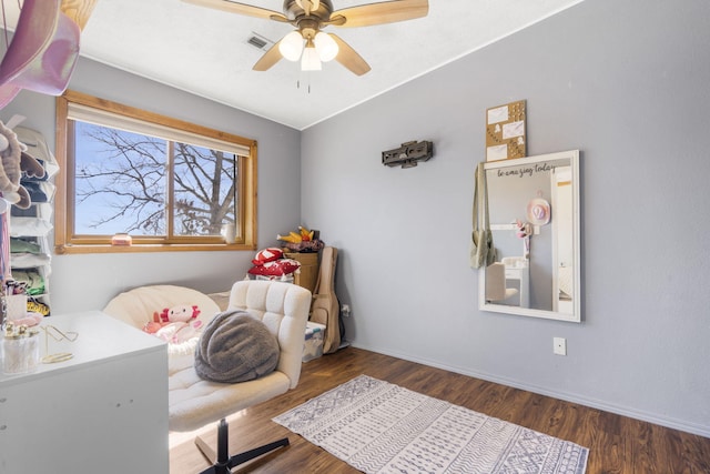 interior space featuring a ceiling fan, wood finished floors, visible vents, and baseboards