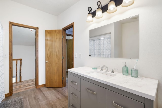 full bathroom with wood finished floors and vanity