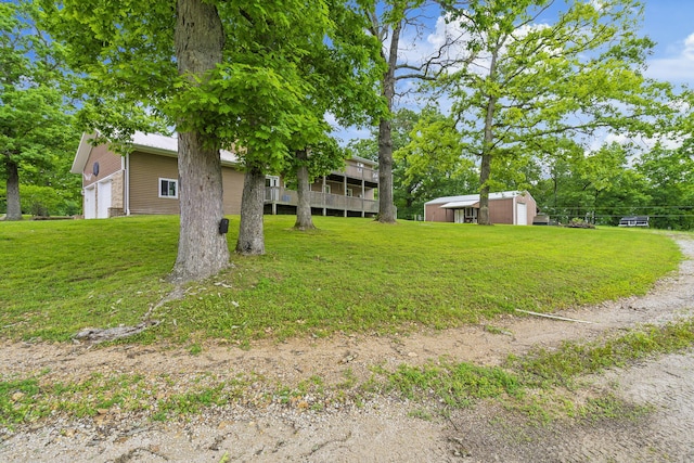 view of yard with a wooden deck and an outdoor structure