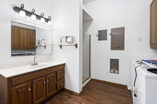 bathroom featuring vanity, wood finished floors, electric panel, separate washer and dryer, and a shower stall