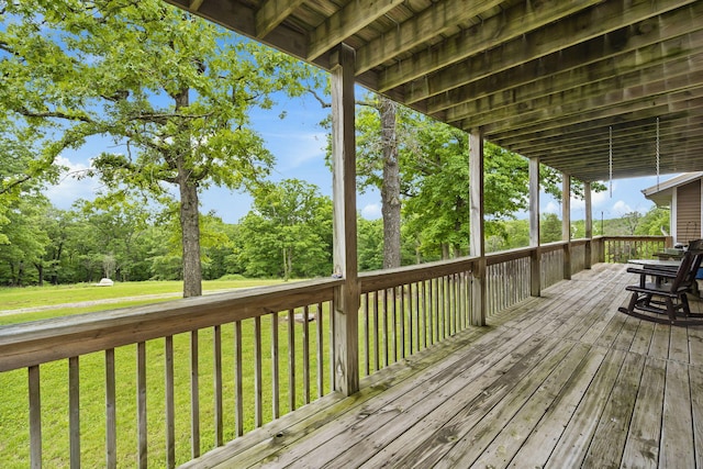 wooden deck with a lawn