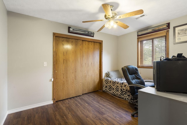 office space featuring ceiling fan, wood finished floors, visible vents, and baseboards