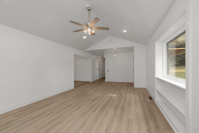 interior space with vaulted ceiling, a healthy amount of sunlight, light wood-type flooring, and ceiling fan