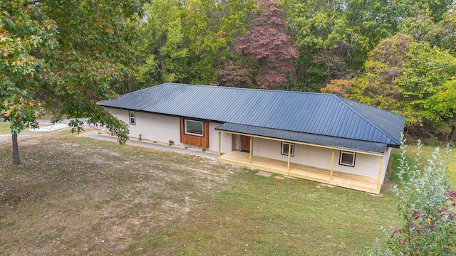 ranch-style house featuring metal roof and a front lawn