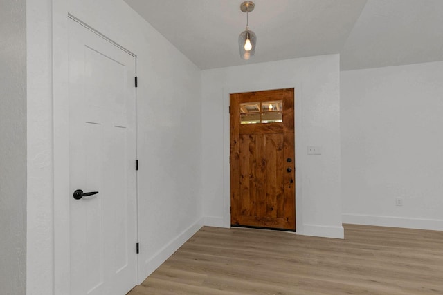 entrance foyer with baseboards and light wood-style floors