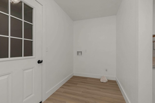 washroom featuring laundry area, light wood-style flooring, baseboards, and hookup for a washing machine