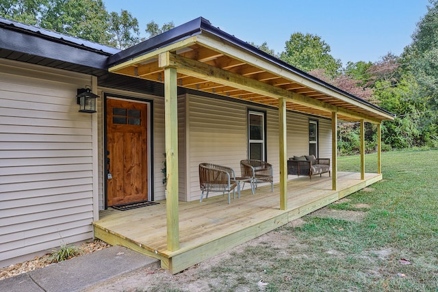 view of exterior entry with a yard