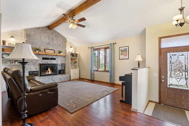 living area with lofted ceiling with beams, baseboards, wood finished floors, and a fireplace