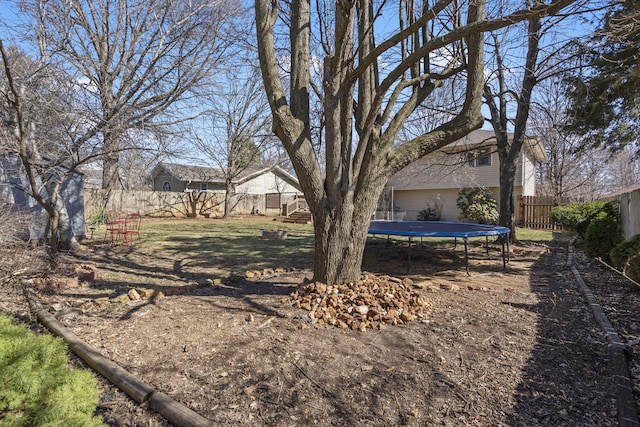 view of yard featuring a fenced backyard and a trampoline