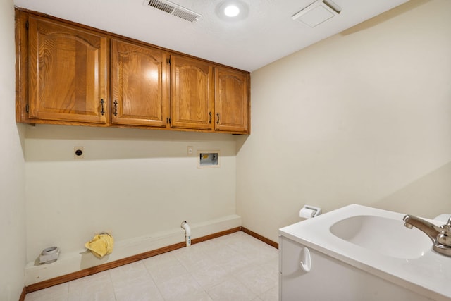 laundry area with electric dryer hookup, visible vents, a sink, cabinet space, and hookup for a washing machine