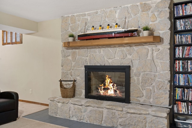 room details with a fireplace, baseboards, and carpet floors