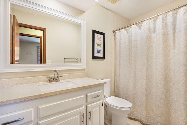 bathroom with toilet and vanity