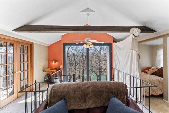 sitting room with carpet, vaulted ceiling with beams, an upstairs landing, and a ceiling fan