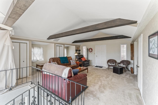 carpeted living room with lofted ceiling with beams and a textured wall