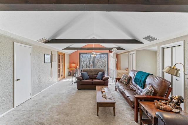 living area featuring lofted ceiling with beams, a textured wall, visible vents, and light carpet