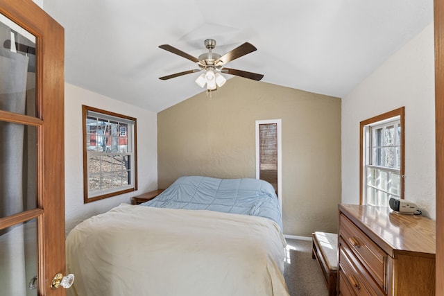 bedroom featuring carpet flooring, baseboards, ceiling fan, vaulted ceiling, and a textured wall