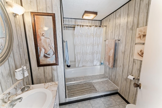 bathroom with a shower with curtain, wood walls, and vanity