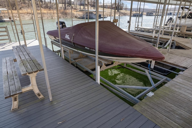 dock area with boat lift and a water view